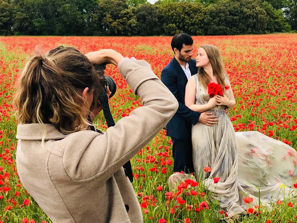 honeymoon couple have romantic photograph taken with red poppies