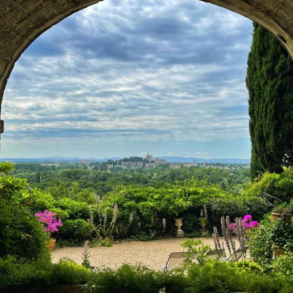 view of Avignon through archway on Emily's April Tour of Provence