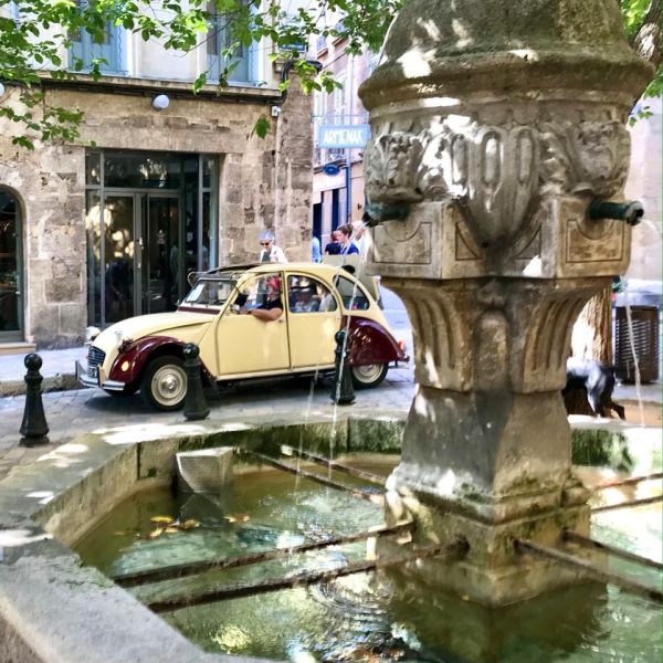 vintage car near French village fountain
