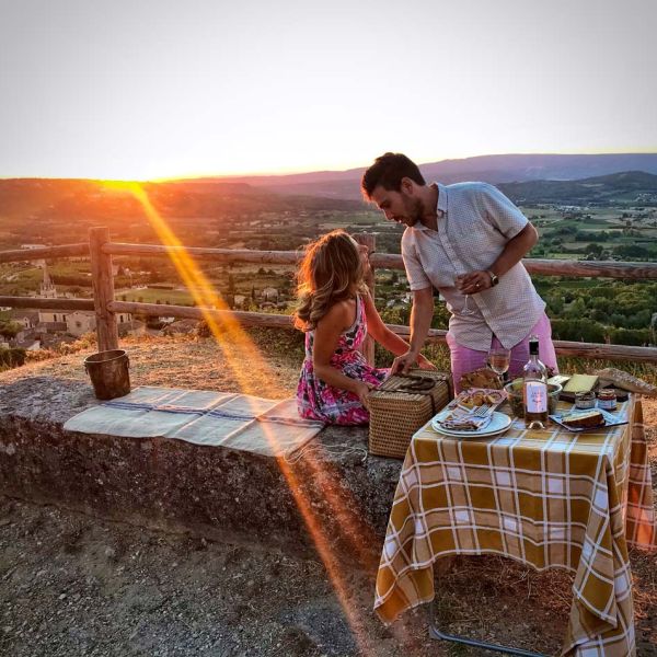 couple having romantic sunset gourmet picnic on honeymoon tour of Provence