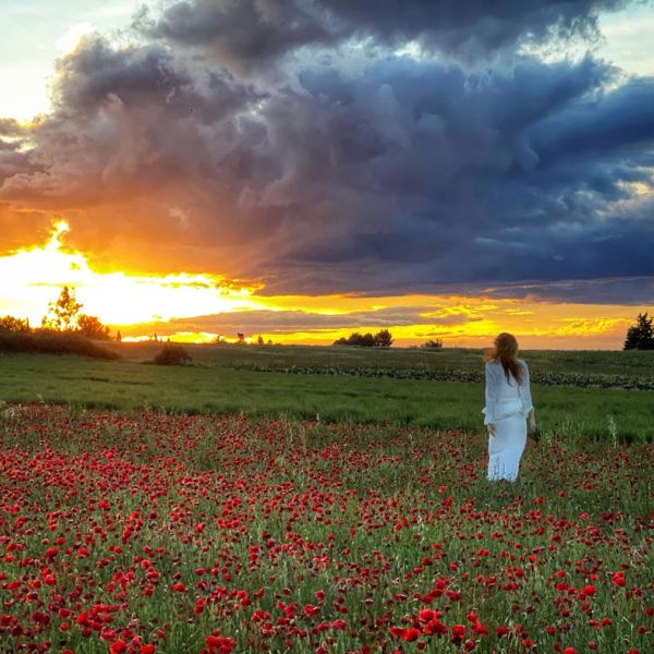 tour guide Emily Durand enjoys sunset in poppy field